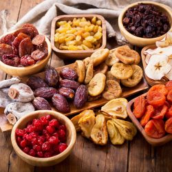 various dried fruits on wooden table, top view